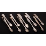 Two Irish and three English silver pairs of sugar tongs,