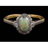 An 18ct gold, opal and diamond cluster ring: the oval opal approximately 6.5mm long x 4.