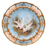 A Royal Worcester cabinet plate by Charley Baldwyn: painted with five swans in flight amongst reeds