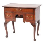 An 18th Century oak lowboy:, the rectangular top with a moulded edge,
