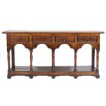 An early 18th Century oak dresser base:, the top with a moulded edge,