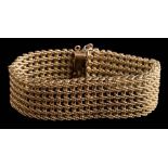 A 9ct gold pierced mesh-link bracelet: approximately 18cm long x 2.2cm wide, 49gms gross weight.