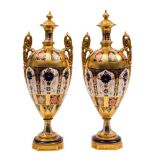 A pair of Royal Crown Derby two-handled vases and integral covers: in the 'Old Imari' pattern with