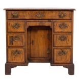 An early 18th Century walnut and diagonally banded kneehole desk:, of small size,