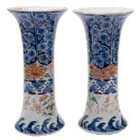 A pair of Japanese Imari trumpet vases: painted with peony and chrysanthemum sprays in iron-red,
