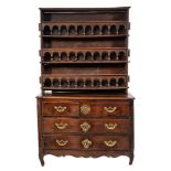A Louis XV Provincial walnut serpentine fronted commode:, the top with a moulded edge,