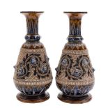 A pair of Doulton Lambeth stoneware vases attributed to George Tinworth: incised with a scrolling