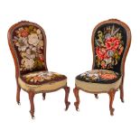 A pair of Victorian carved walnut nursing chairs: with cartouche-shield and foliate crestings,