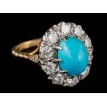 A turquoise and diamond oval cluster ring: the oval turquoise approximately 10mm long x 7.
