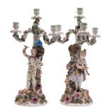 A pair of Sitzendorf four-light candelabra: modelled as male and female jesters with monkey