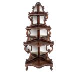 A Victorian carved rosewood serpentine fronted four tier standing corner whatnot:,