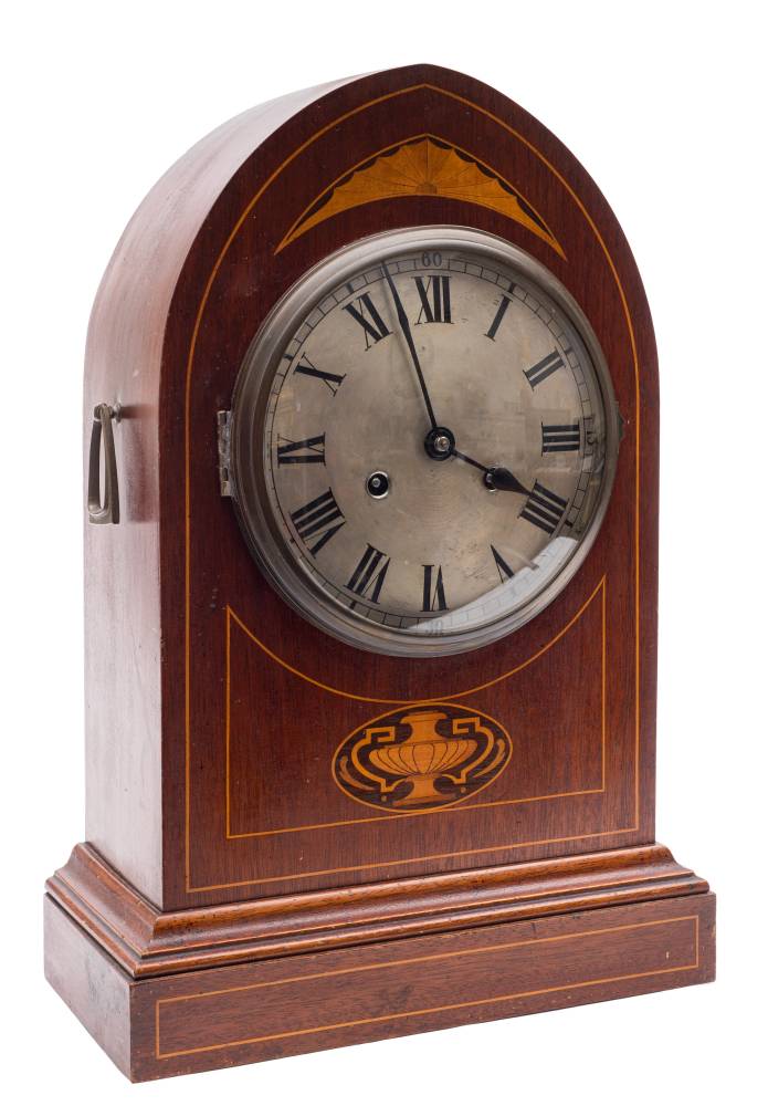 A lancet-shaped mantel clock: the eight-day duration movement striking the hours and half-hours on