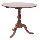 A George III mahogany circular tea table: with a snap top,