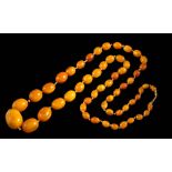 A graduated natural amber bead, single-string necklace: with 56 oblong beads graduated from 10.