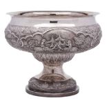 An Indian silver pedestal bowl: with embossed decoration of village scenes with elephants,