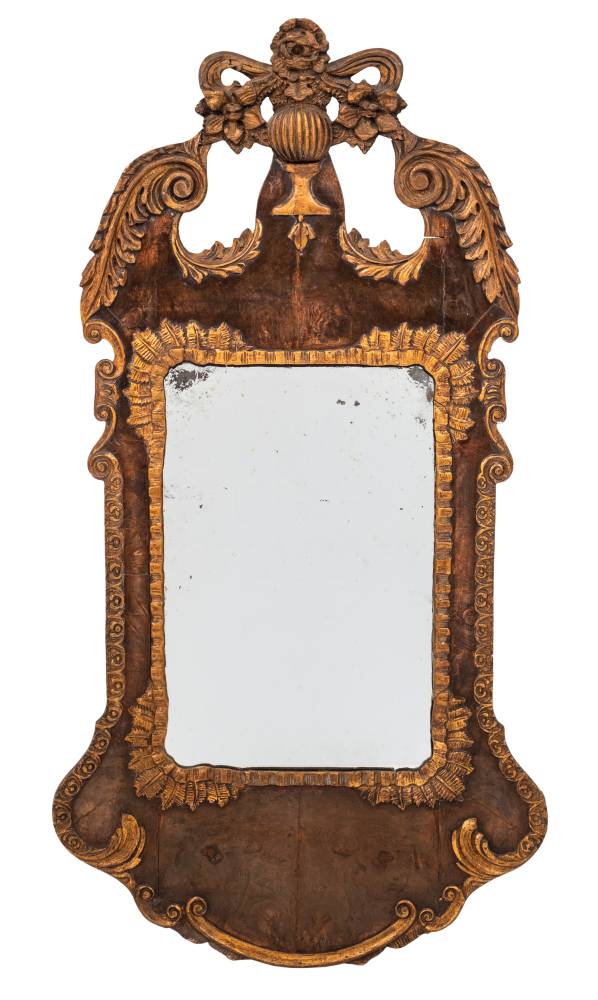 A Continental walnut and giltwood wall mirror: of cartouche outline,