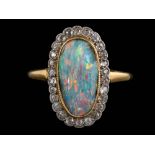 A black opal and diamond oval cluster ring: the oval black opal approximately 14.5mm long x 7.