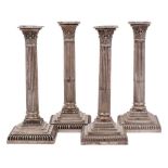 A near matching set of four Victorian silver Corinthian column candlesticks, maker Hawksworth,