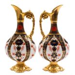 A pair of Royal Crown Derby ewers: in the 'Old Imari' pattern with solid gold borders,