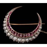 A 19th Century ruby and diamond crescent brooch: set with graduated round,