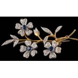 An 18ct gold, sapphire and diamond floral spray brooch: approximately 54mm long, 12gms gross weight.