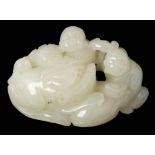 A Chinese carved jade figure group: of two seated figures beside a recumbent qilin, 7.5cm. wide.