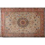 A Tabriz carpet:, the pistachio field with a central circular geometric flowerhead pole medallion,