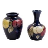 Two Moorcroft pottery small vases: one of globular form with raised flaring neck the other of