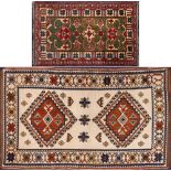 A Kurdish rug:, the ivory field with twin lozenge stepped geometric medallions,