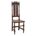 A Carolean carved beechwood dining chair: the high cane panel back with foliate scroll cresting and