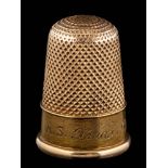 A thimble initialled and dated '1891', together with fitted case stamped 'Harrods London S.W'.