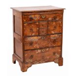 An 18th Century burr yew-wood and oak Norfolk chest:, the top with a moulded edge,
