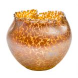 A glass vase in the Loetz manner: of oviform with serrated asymmetric rim the pale amber body with