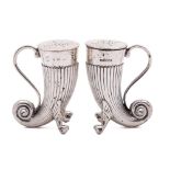 A pair of Victorian silver cornucopia peppers, maker Horace Woodward & Co, Birmingham,