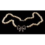 A cultured pearl single-string necklace centring a white gem-set ribbon bow: approximately 33gms