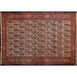 A Senha rug:, the beige field with an all over geometric boteh design,