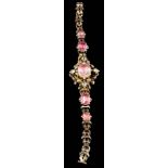 A mid 19th Century gold and pink foiled topaz bracelet: with graduated oval pink foiled topaz in