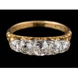 An 18ct gold and graduated diamond five-stone ring: with round old, brilliant-cut diamonds,