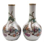 A pair of Chinese famille rose bottle vases: each painted with a group of five scholars in an