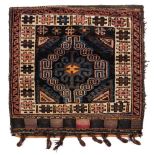 A Belouchistan saddle bag:, the shaded field with a hooked lozenge design,