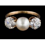A gold, pearl and diamond three-stone ring: with central button pearl 7.