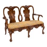 An early 18th Century and later carved walnut twin chair back settee:,