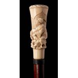 An Oriental malacca walking stick: the carved ivory handle depicting a peasant being pulled by a