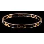 A black onyx panel bangle of pierced design: inside circumference approximately 73mm,