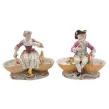 A pair of Meissen figural salts: in the form of a boy and girl,