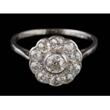 A 20th Century diamond circular cluster ring: mille-grain-set with round old,