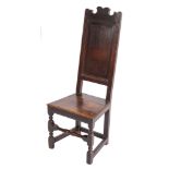 A late 17th/early 18th Century oak dining chair:, the high fielded panel back with shaped cresting,