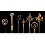 A collection of 12 Masonic gold and gilt metal stick pins: to include an enamelled rose-diamond