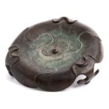 A Chinese bronze tripod stand: of petal-shaped form with ruyi-head feet, Qing, 18cm wide.