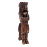 A German carved treen figural nutcracker: of a long haired gentleman in 16th century costume